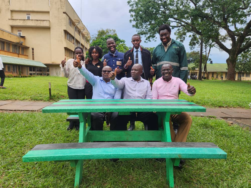 The founders of WastePlus Ltd led by Mr. Sinan Kitagenda with their former Lecturers, Dr. Jamilu E. Ssenku (C) and Dr Samuel Ojelel (R) from the Department of Plant Sciences, Microbiology and Biotechnology, as well as Dr Godfrey Kawooya Kubiriza, Head of the Department of Zoology, Entomology and Fisheries Sciences. The green table is one of the products made by the alumni out of plastic waste